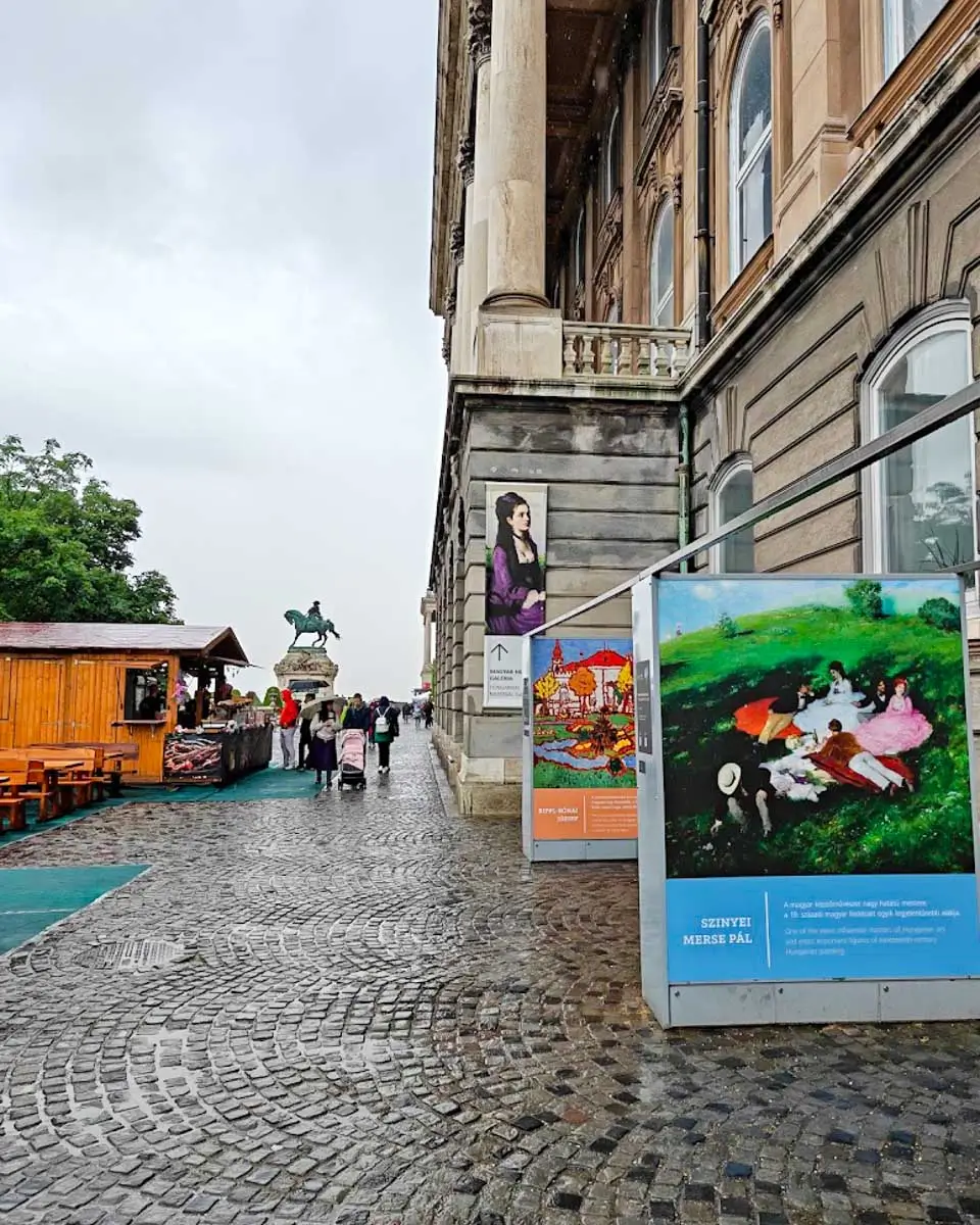 Street view outside the Hungarian National Gallery in Budapest with the museum entrance and surrounding historic buildings