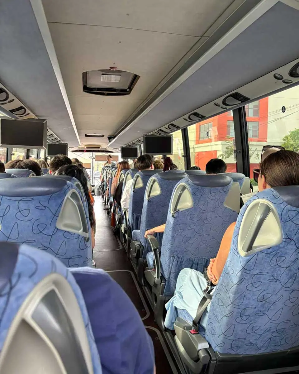 Passengers sitting in a bus on the way to a luau in Hawaii