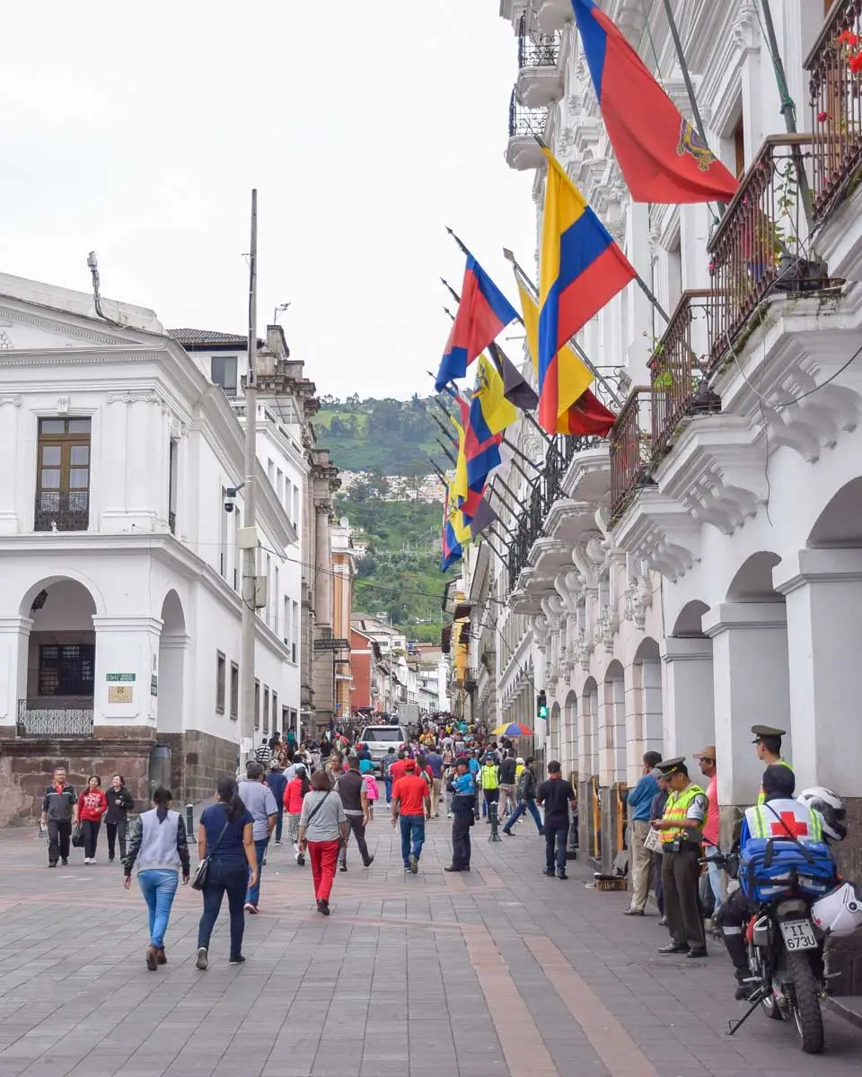 Plaza de la Independencia (Plaza Grande) next to the white colonial arcades of the Municipal Palace and Carondelet Palace in Quito, Ecuador