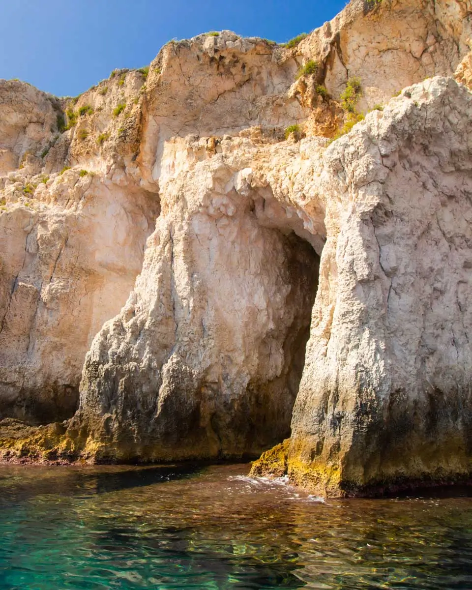 Sea side view of Siracusa coast cliffs, sandstone rocks and caves