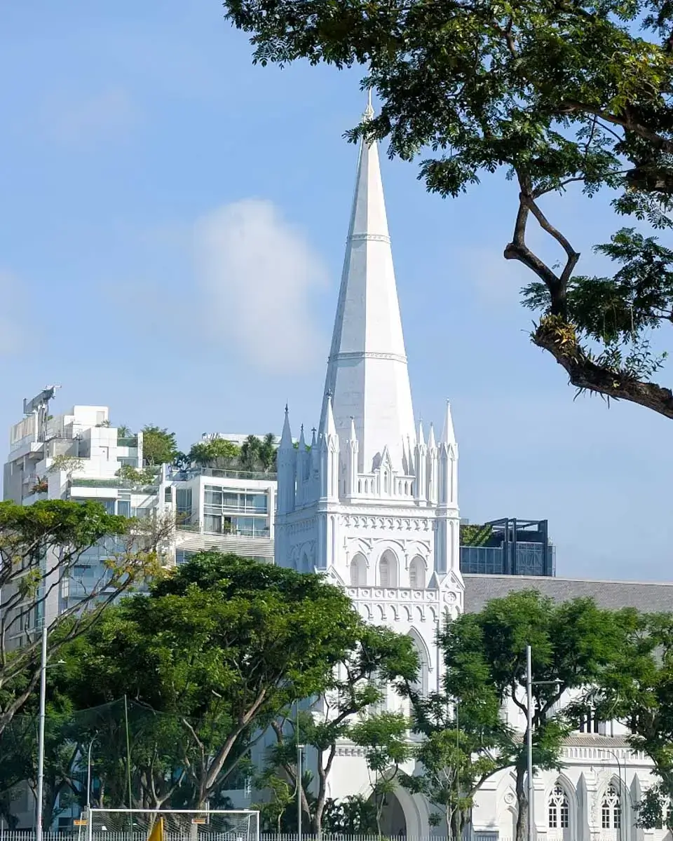 St. Andrew's Cathedral in downtown Singapore with modern skyscrapers in the background