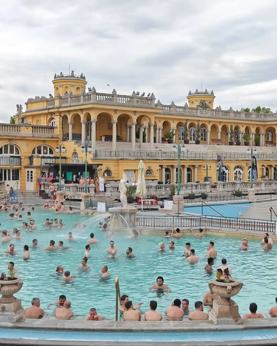 Visitors relaxing in the outdoor thermal pools at Széchenyi Thermal Bath in Budapest
