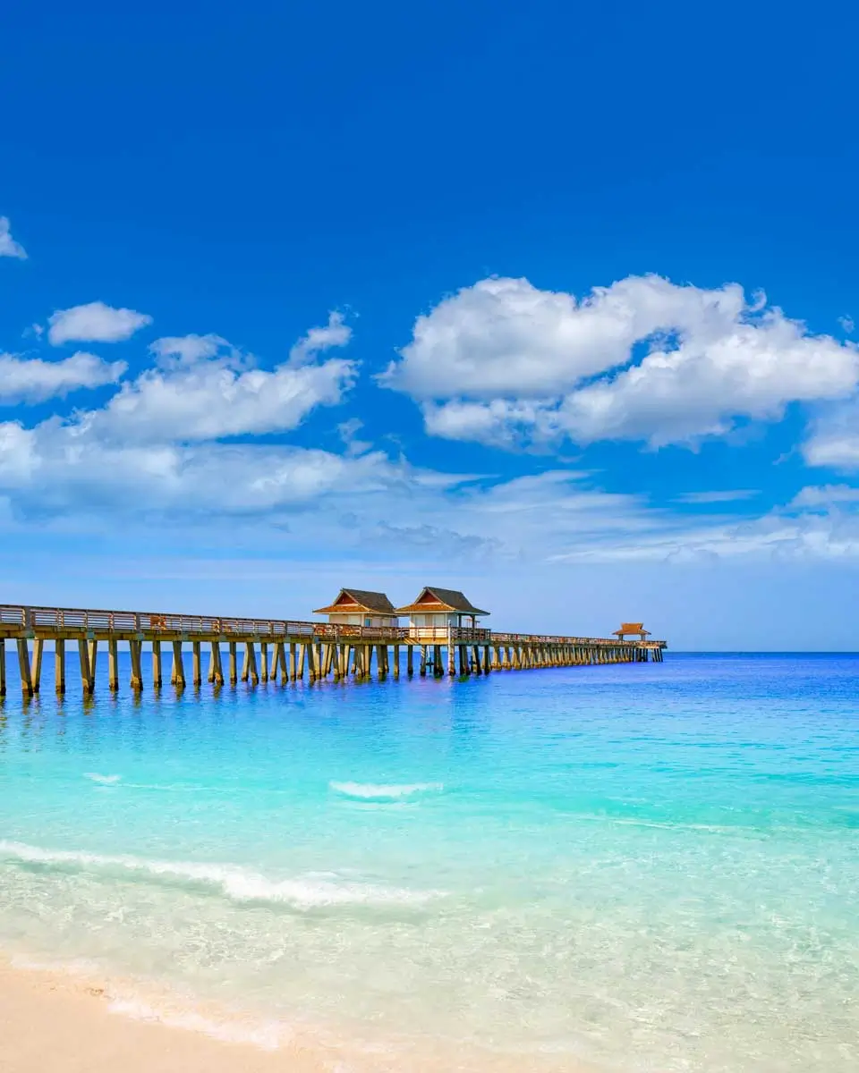 The Naples Pier under a blue sky in Naples Florida
