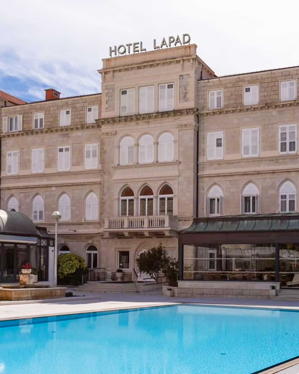 The outside of Hotel Lapad and the pool area