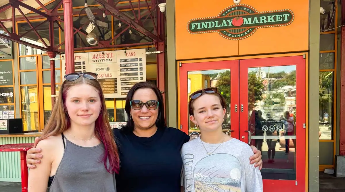Theresa and Family taking photo at Findlay Market in Cincinnati