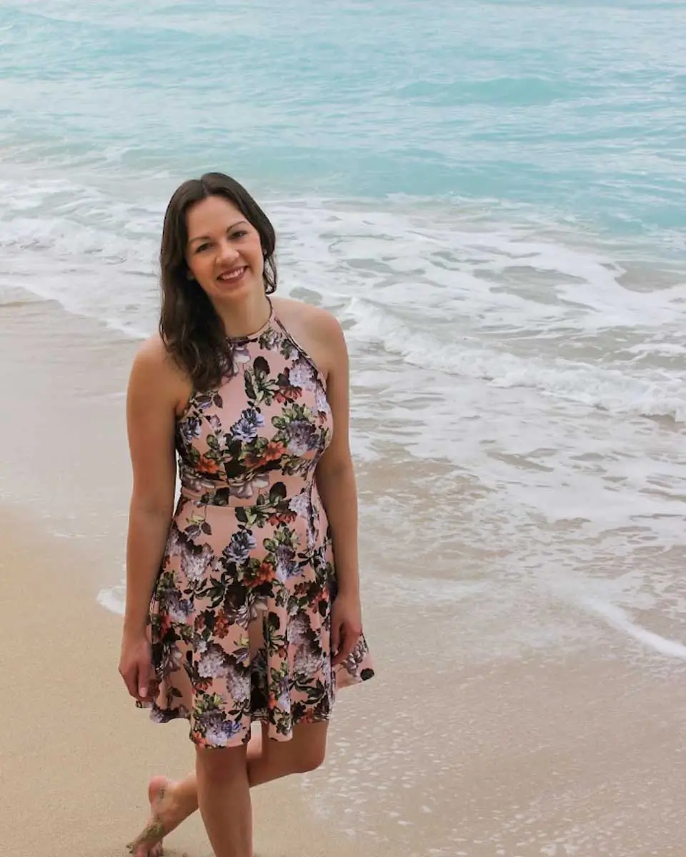 Trelle smiling for a photo at a beach in Hawaii