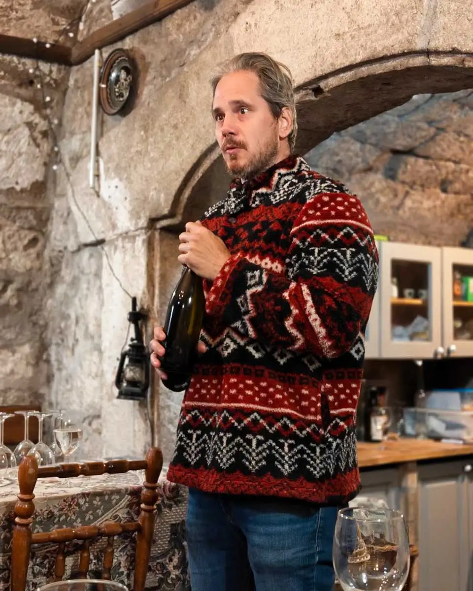 Local vineyard owner Charlie explaining the winemaking process during a wine tour