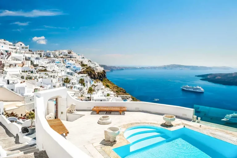 Whitewashed buildings and a rooftop pool seen in Santorini Island, Greece