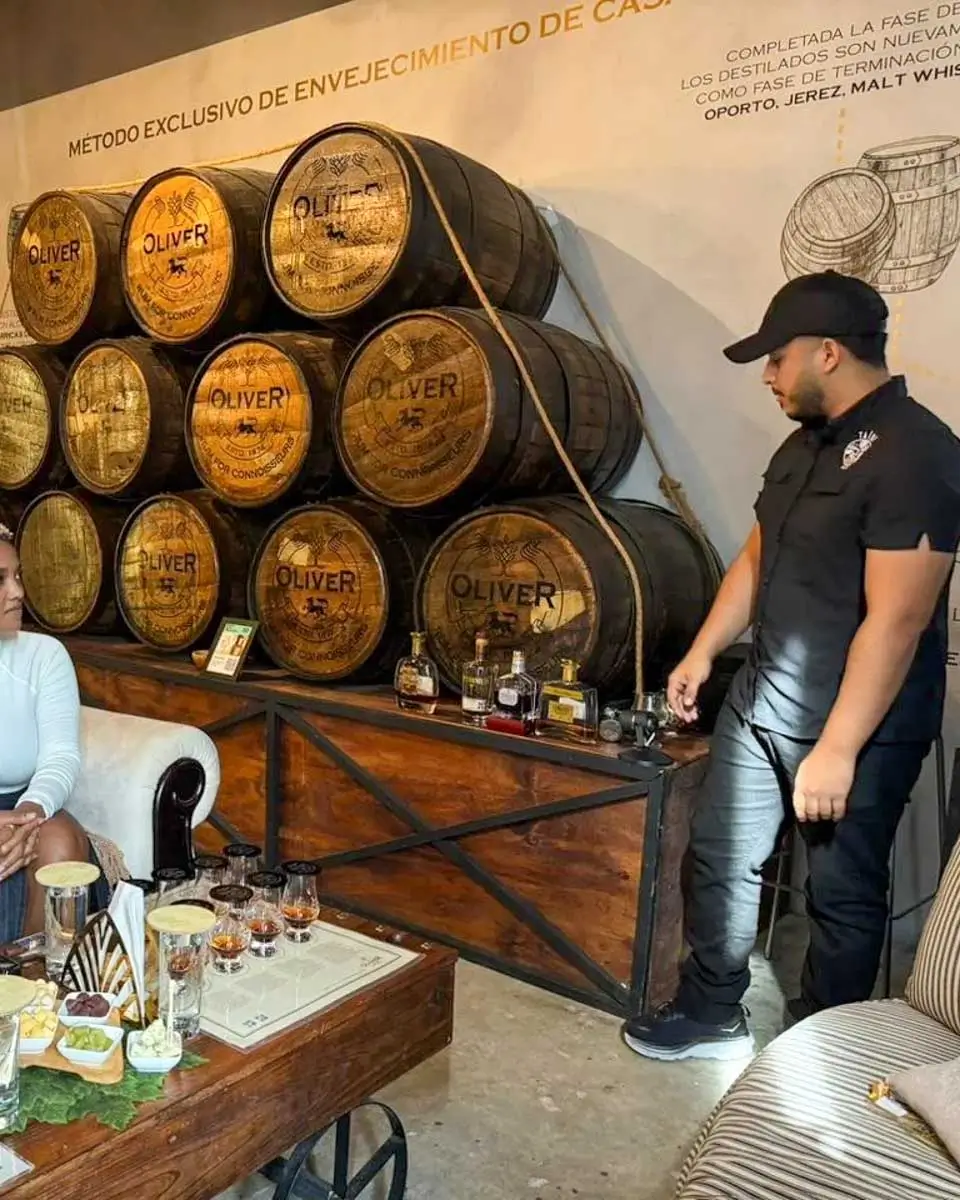 tainogourmet a person picks up a rum sample on a tour from Punta Cana Dominican Republic 4
