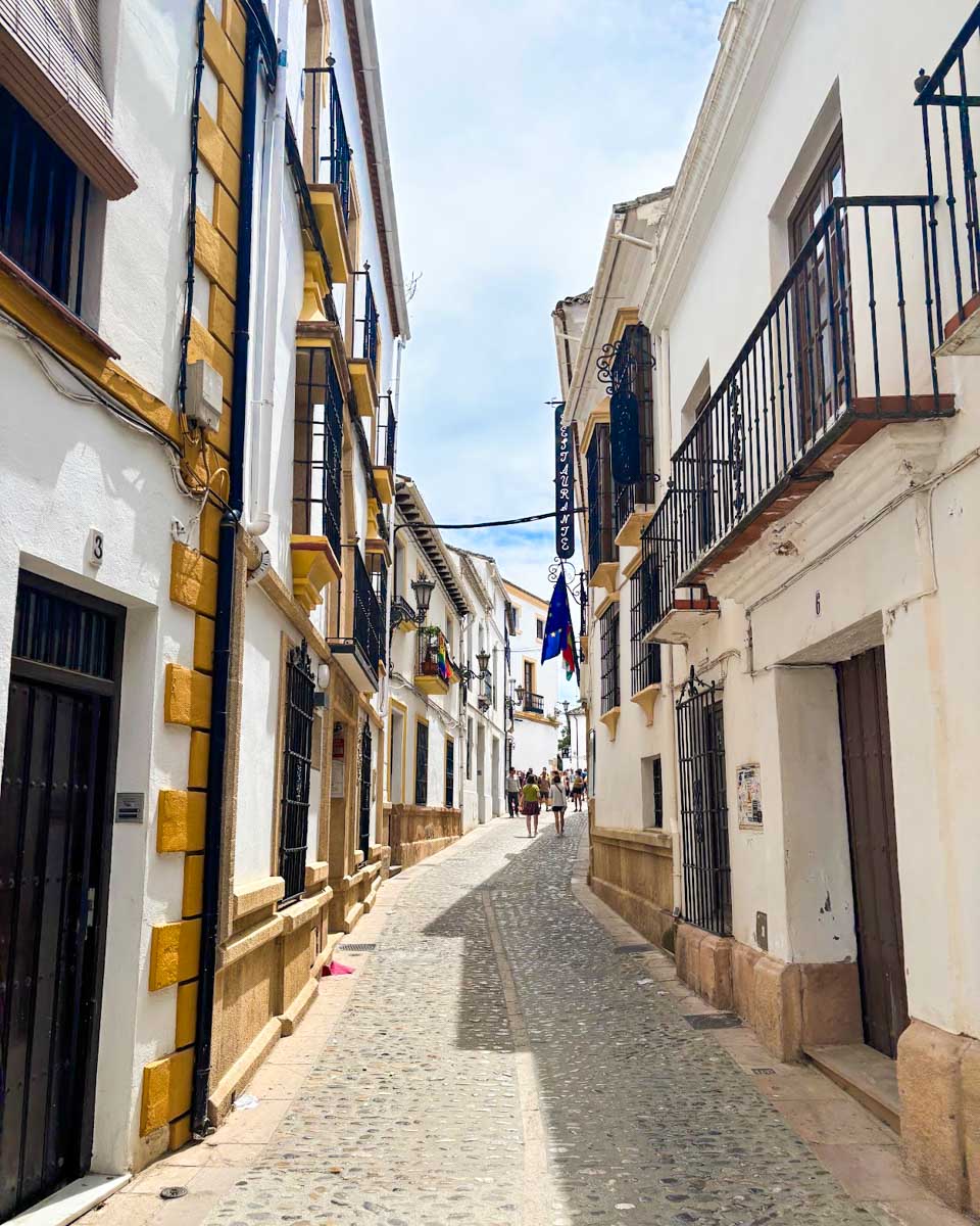 A cobblestone street in the La Ciudad  area of Ronda, Spain