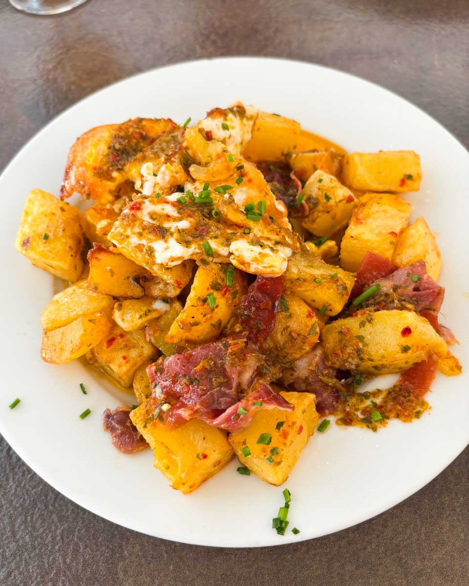 A plate of huevos rotos for lunch at Mercado Central de Atarazanas in Malaga