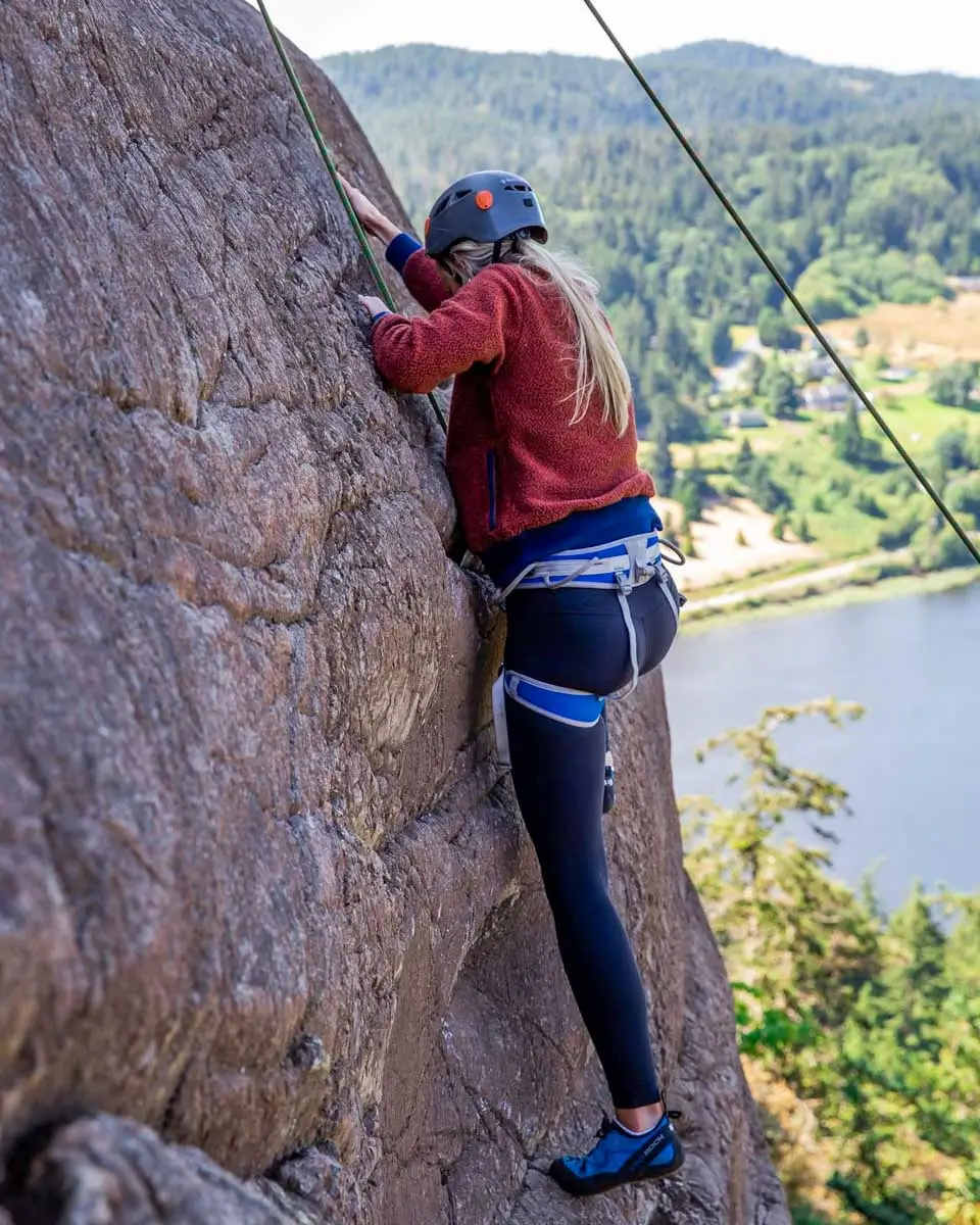 A woman climbing Mount Erie in San Jan Islands, Washington