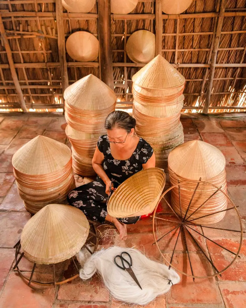A woman making hats seen on a tour from Nha Trang, Vietnam