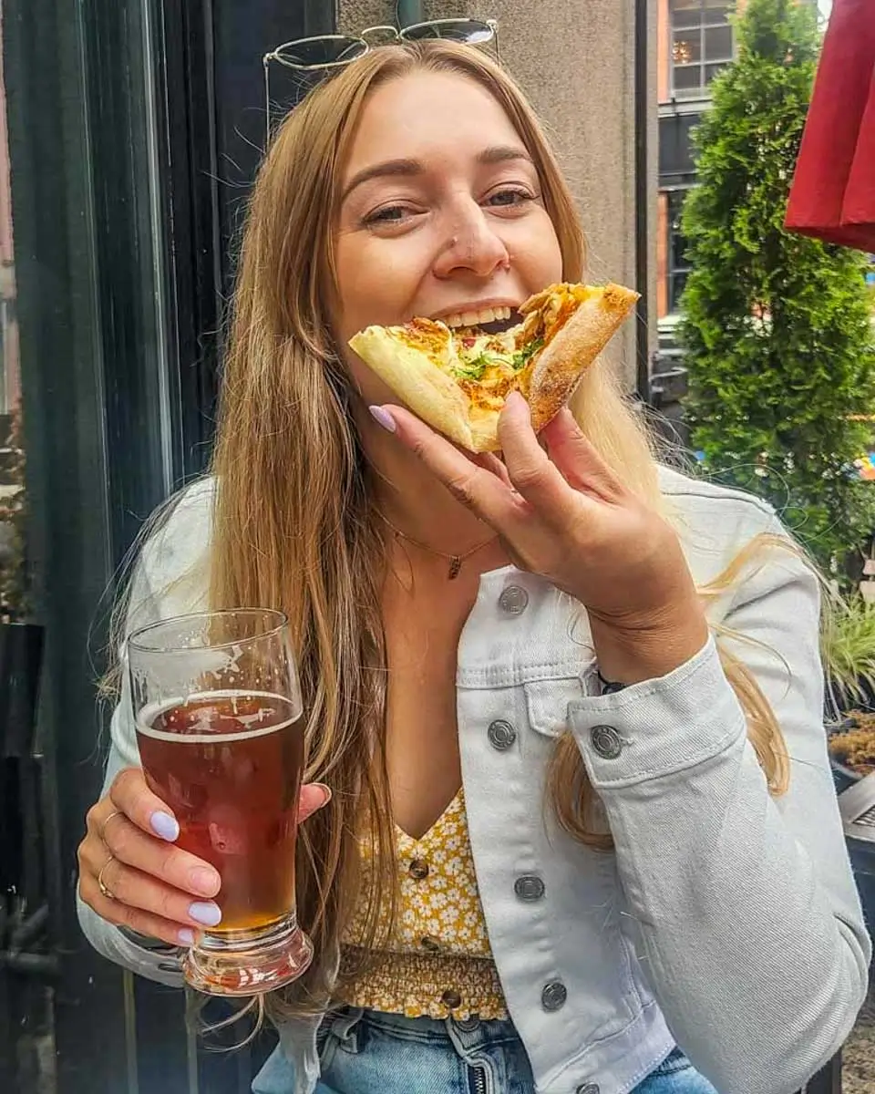 Bailey eats pizza in Byron Bay, Australia