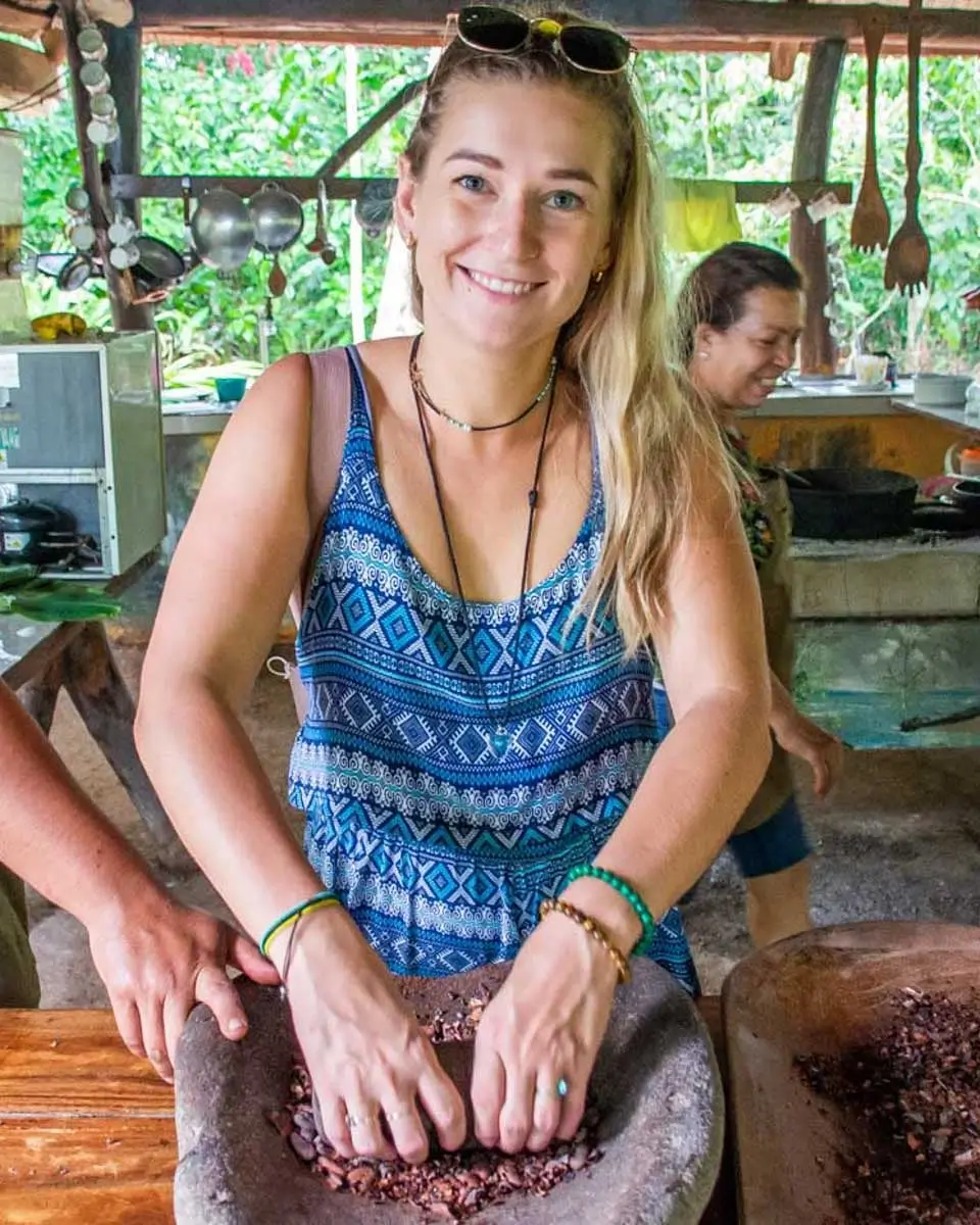 Bailey grinds cocao a traditional way in Roatan, Honduras