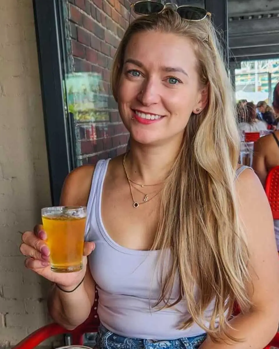 Bailey holding a glass of beer in Australia