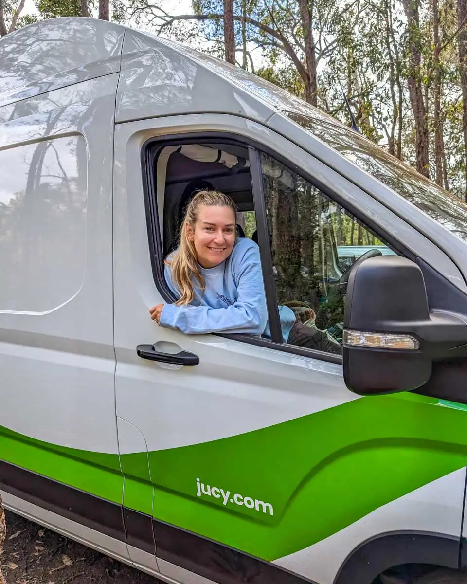 Bailey smiles in JUCY campervan on the way to Rainbow Beach, Australia