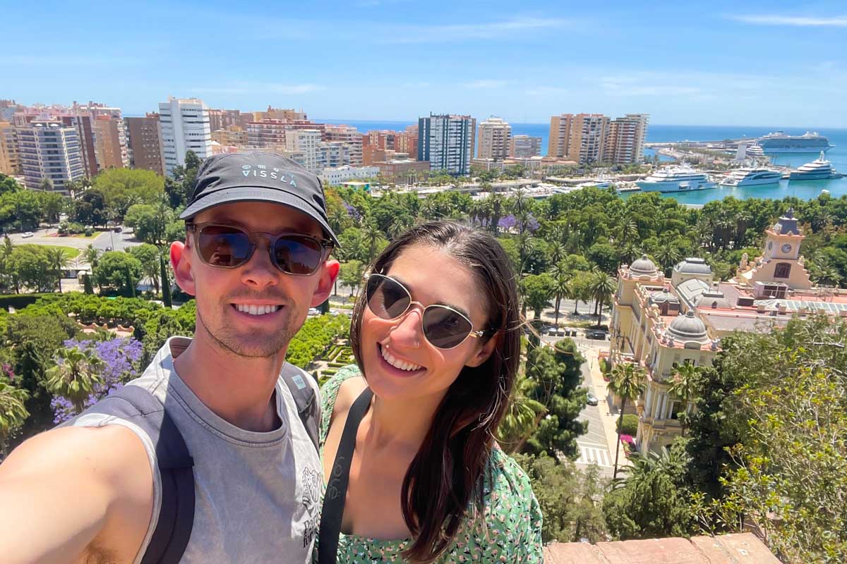 Brittni and Jesse take a selfie with Malaga city and harbor in the background