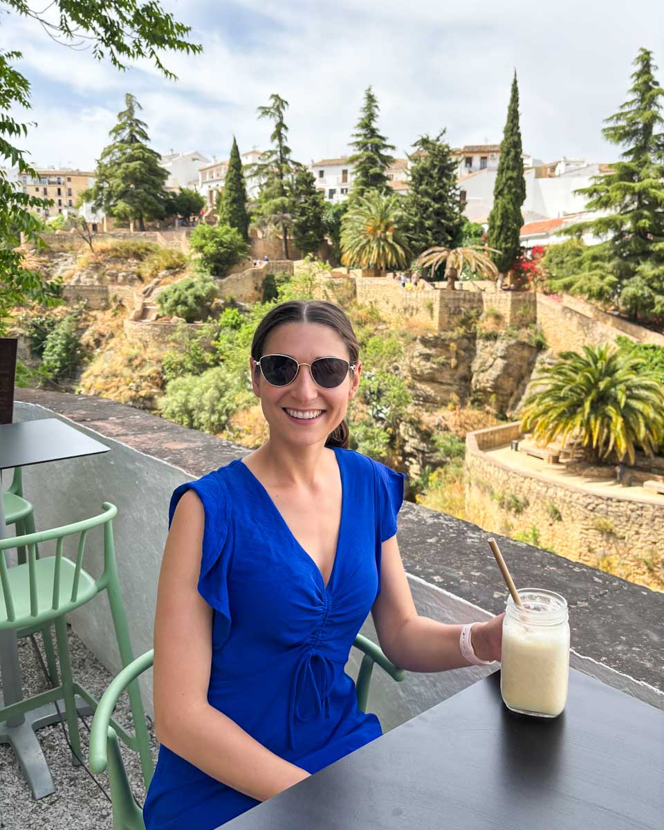 Brittni enjoys a smoothie overlooking the gorge in Ronda, Spain
