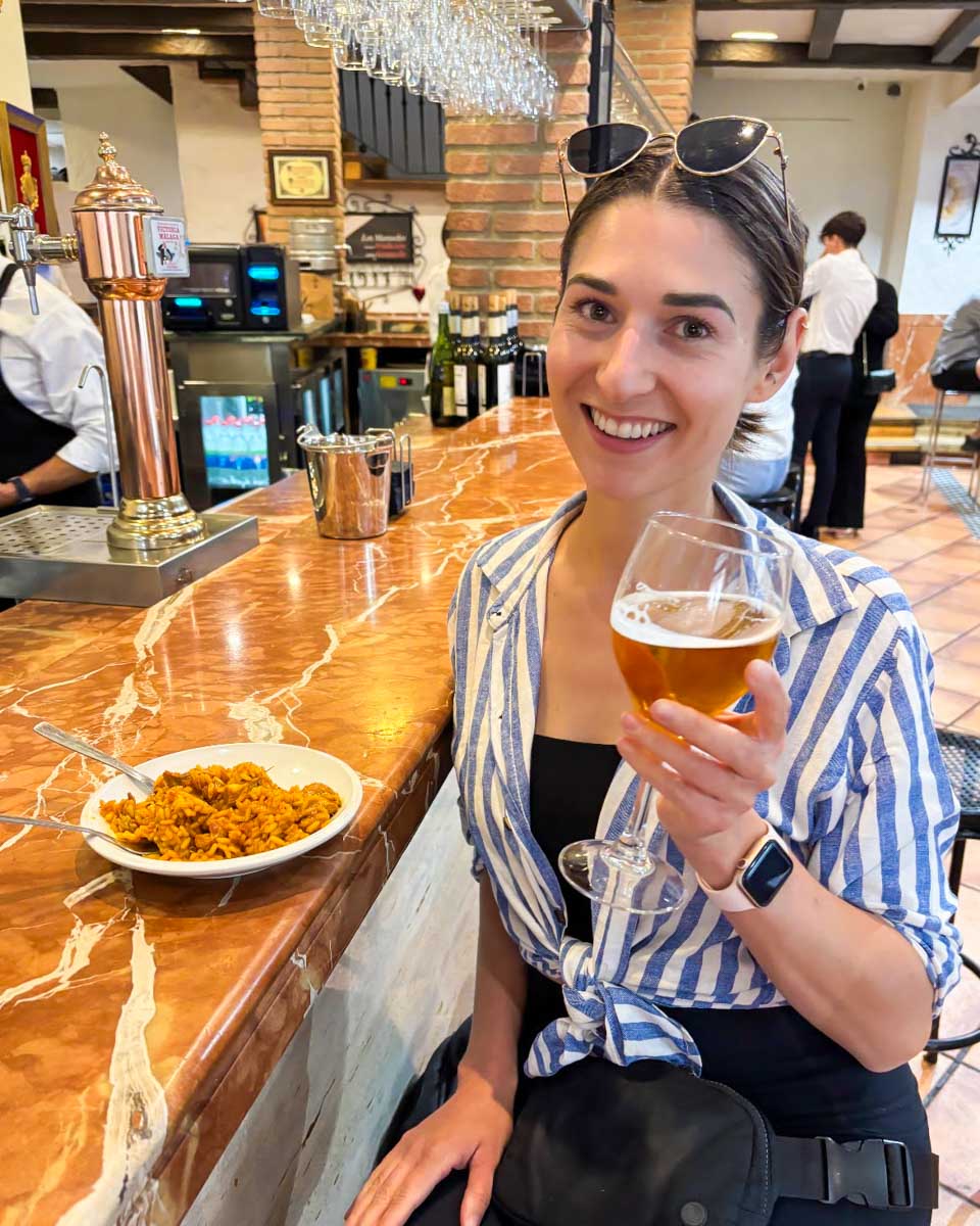 Brittni has a beer and some tapas at a bar in Malaga, Spain