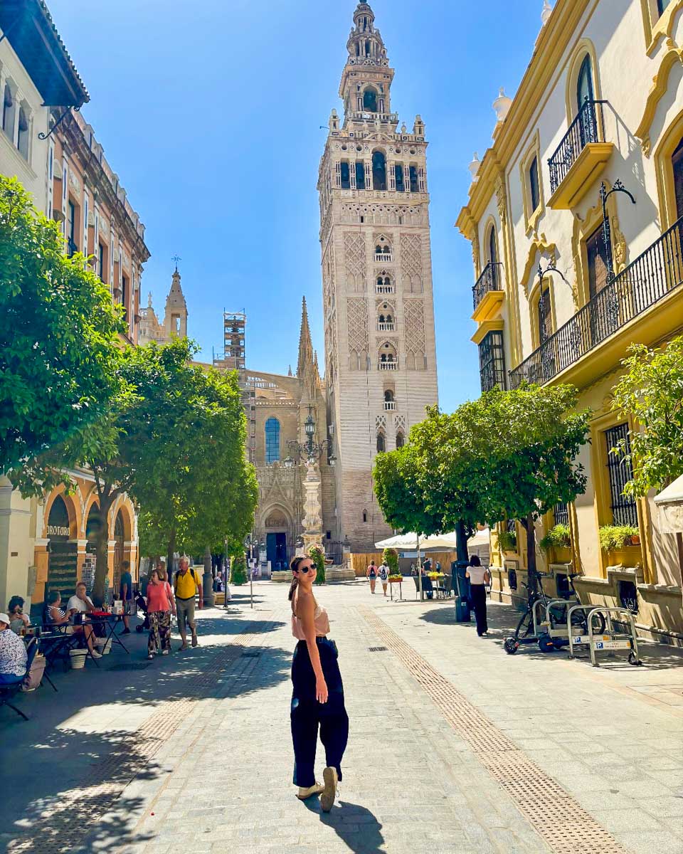 Brittni poses for a photo on a street with the cathedral in the background
