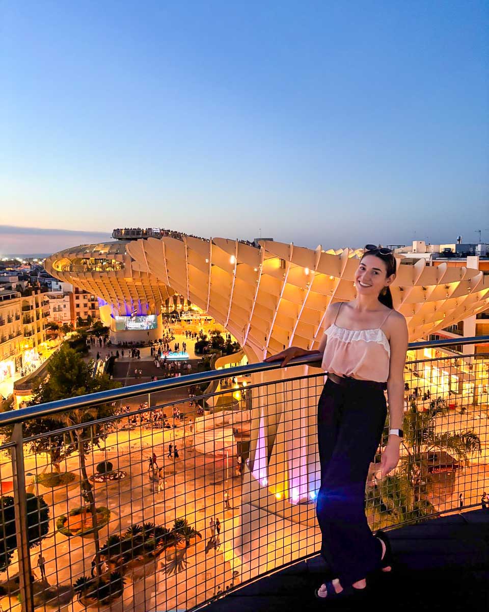 Brittni takes a picture in front of Las Setas in Seville at dusk