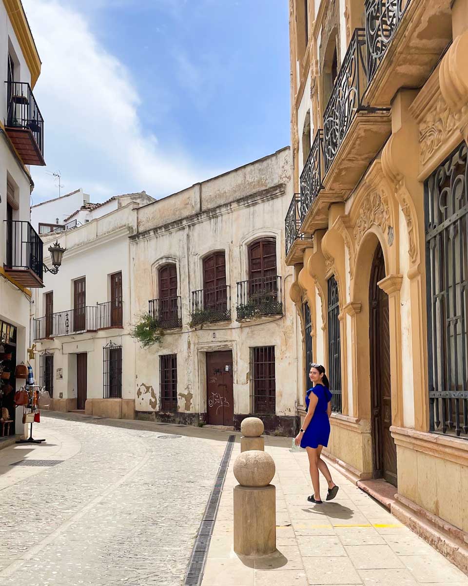Brittni walks along a historic street in La Ciudad area of Ronda, Spain