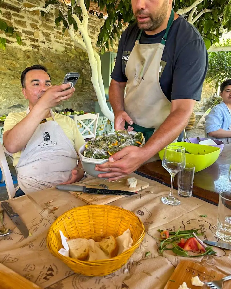 Chef showing a traditional dish during a cooking class in Naxos, Greece