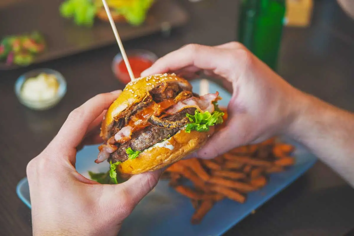 Daniel eats a burger in Baltimore, Maryland