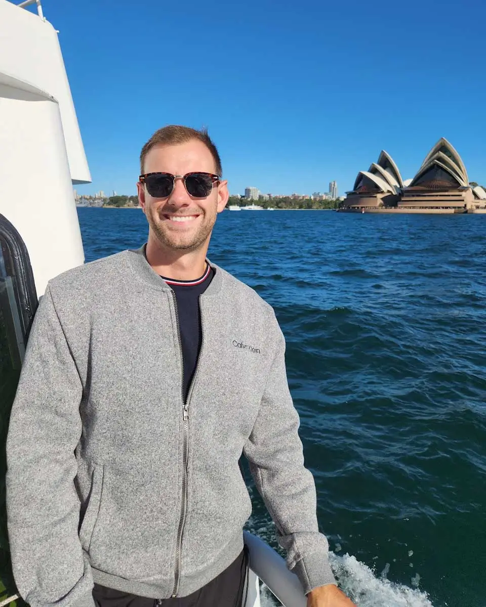 Daniel taking a selfie on cruise with Sydney Opera House in background