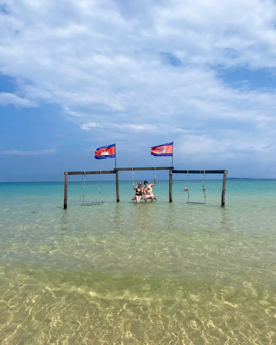 Evan and Sarah sitting on a swing in Koh Rong, Cambodia