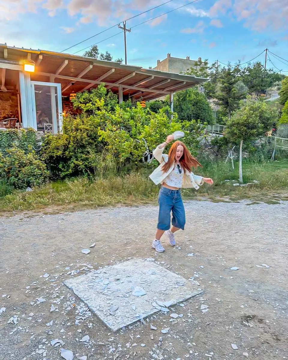 Hannah smashing plates in cooking class in Naxos, Greece