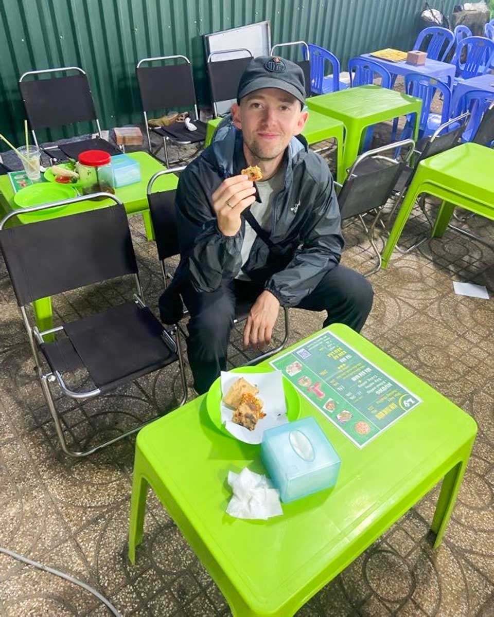 Jesse eats food at the Dalat Night Market in Vietnam
