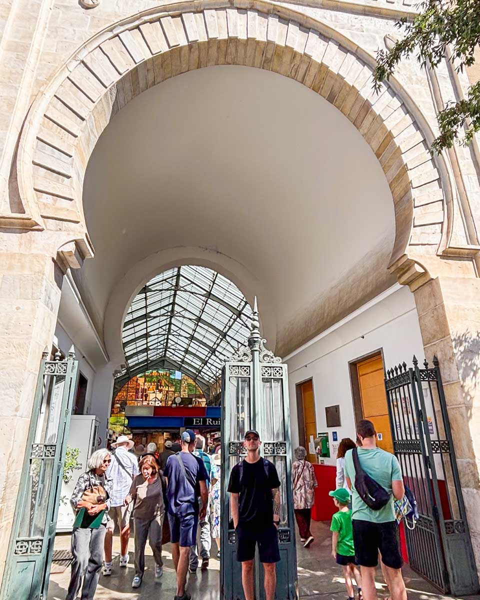 Jesse stands under the arch enterance at the Mercado Central de Atarazanas in Malaga