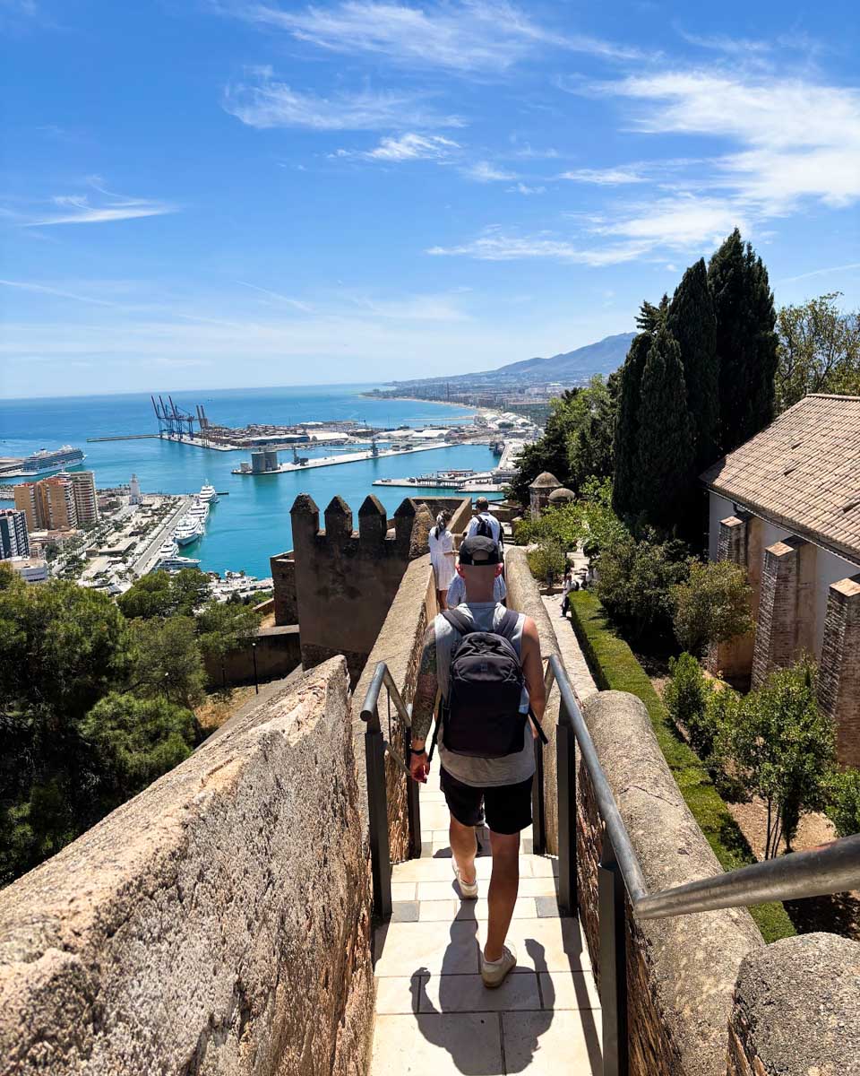 Jesse walks along the wall of Gibralfaro castle in Malaga