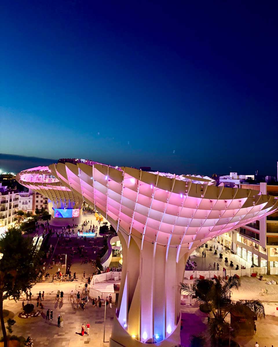 Las Setas lit up at night seen from a nearby hotel terrace in Seville