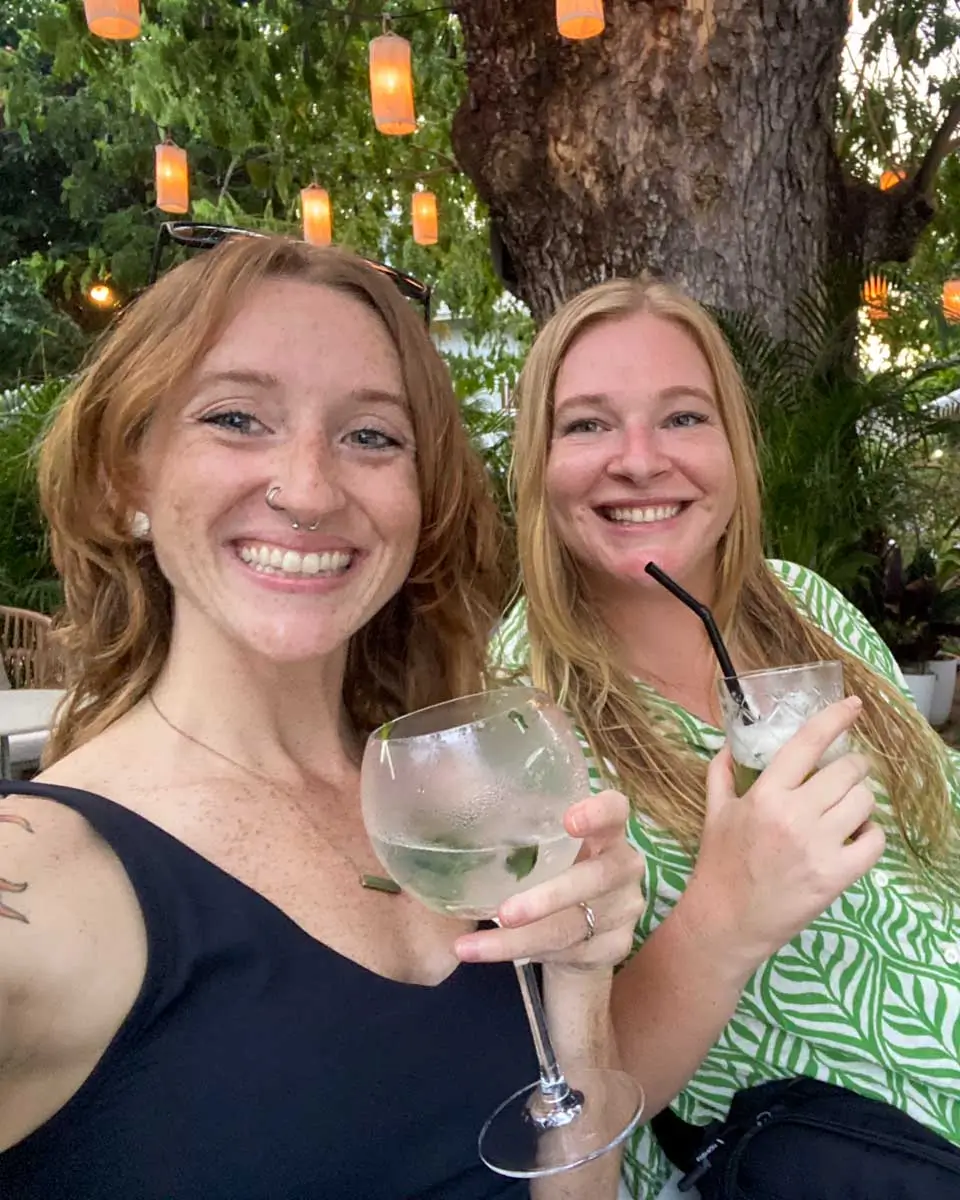 Meghan and Sarah drink a cocktail on the Mekong River in Luang Prabang, Laos