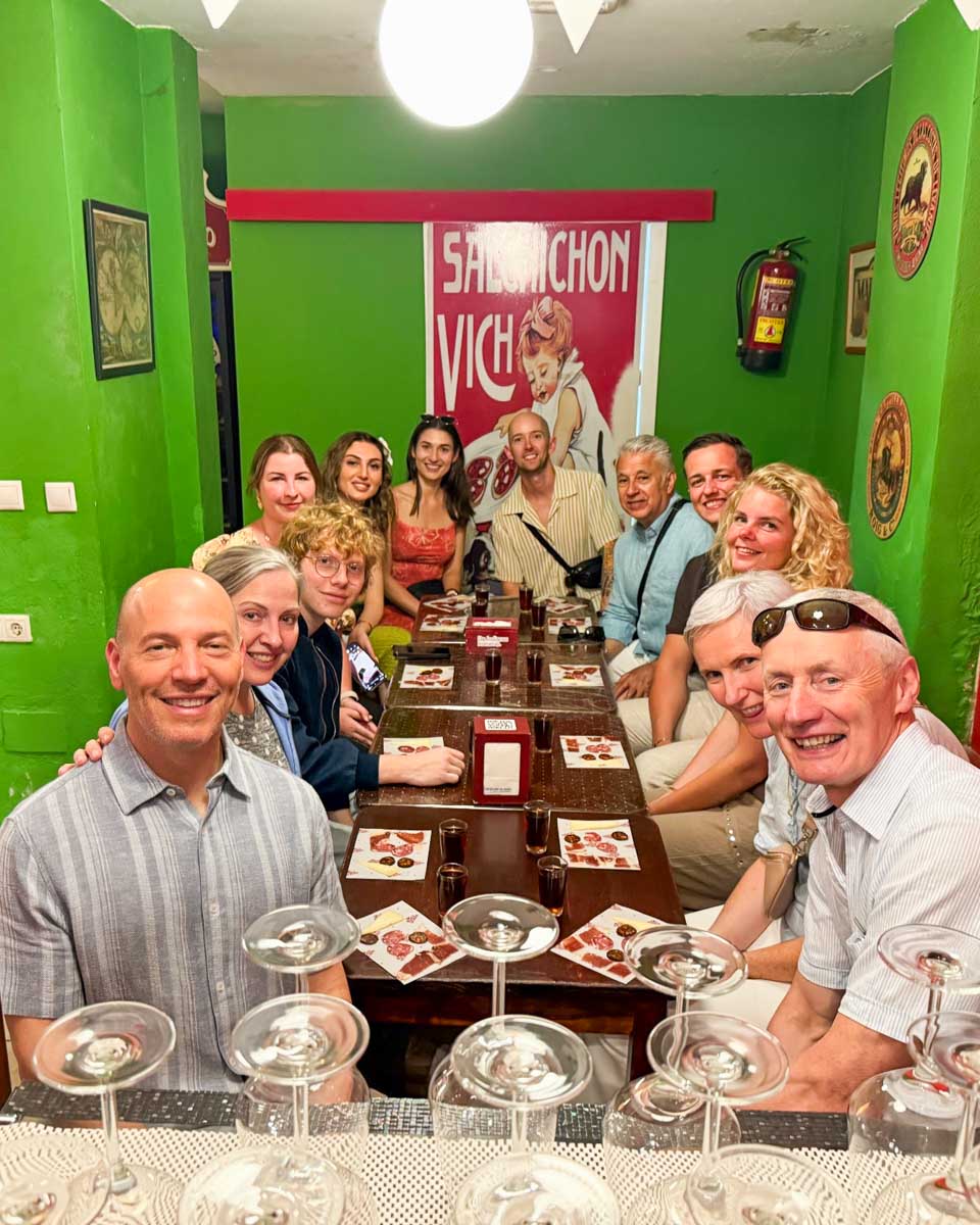 Our food tour group smiles for a photo in Malaga
