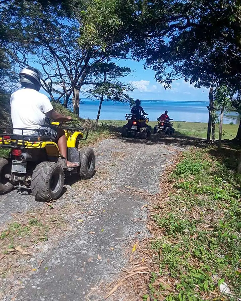 People riding ATV on a tour in Roatan Honduras
