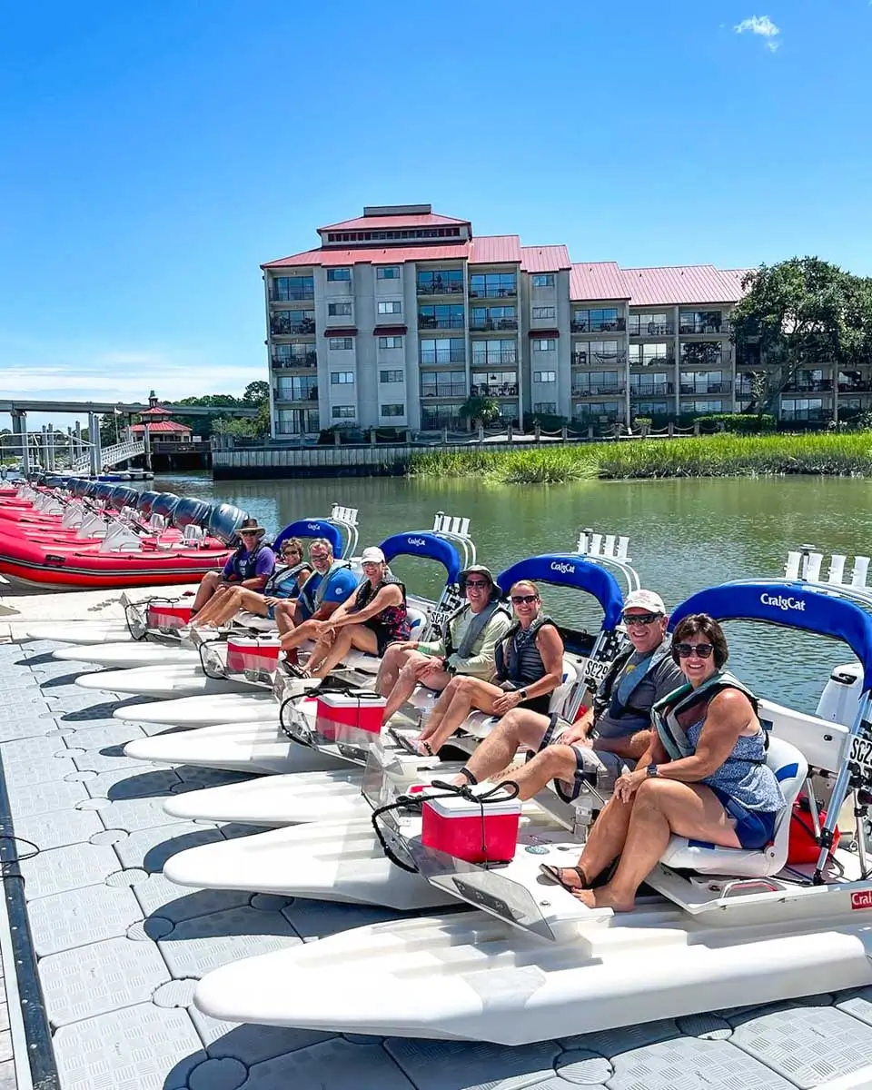 People sitting in creek cat boats ready to get on water in Hilton Head Island, USA