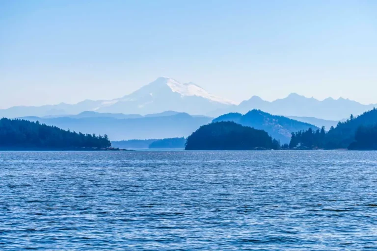 Telephoto view of Mt Baker in hazy distance through Obstruction Pass in San Juan Islands of Washington