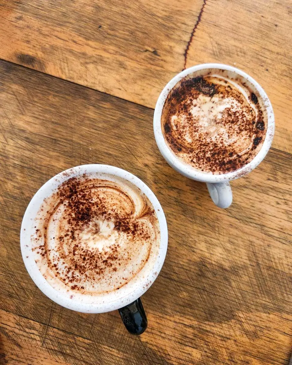 Two coffees on a wooden table in Mission Beach, Australia