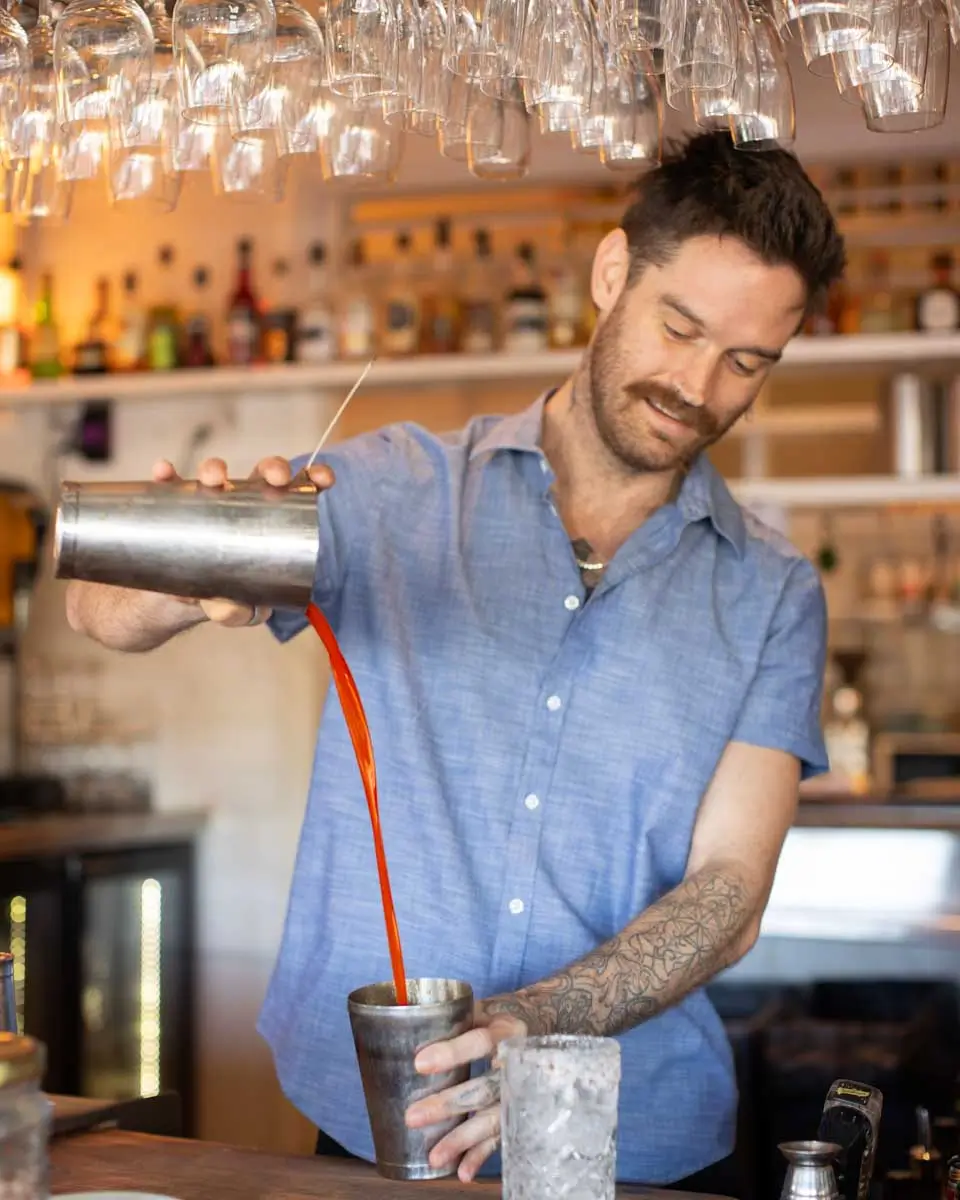 man pouring cocktail at The Balcony Bar & Oyster Co. in Australia