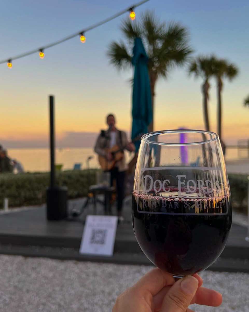 A glass of wine held up at Doc Ford’s Rum Bar & Grill in Fort Myers Florida