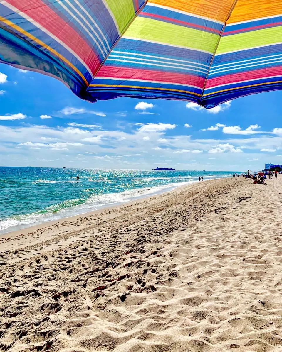 An umbrella and sand on Fort Lauderdale Beach, Fort Lauderdale, Florida