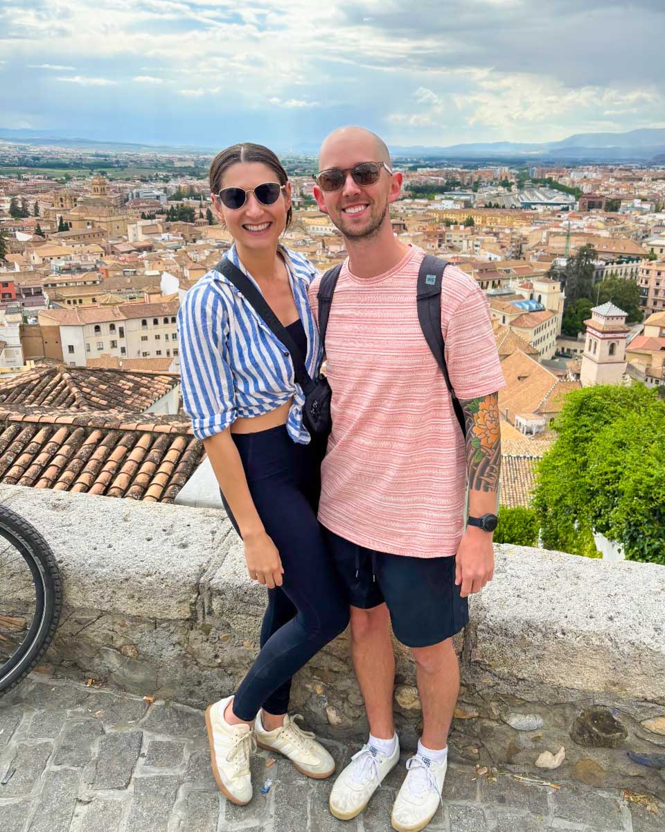 Brittni and Jesse pose for a photo with Granada in the background on a tour