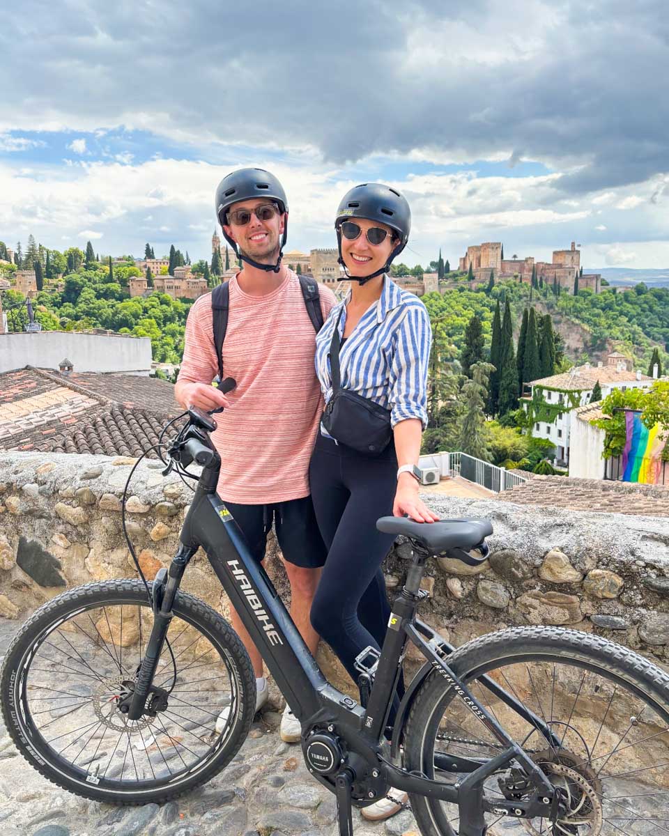 Brittni and Jesse pose with their e-bike on a tour in Granada