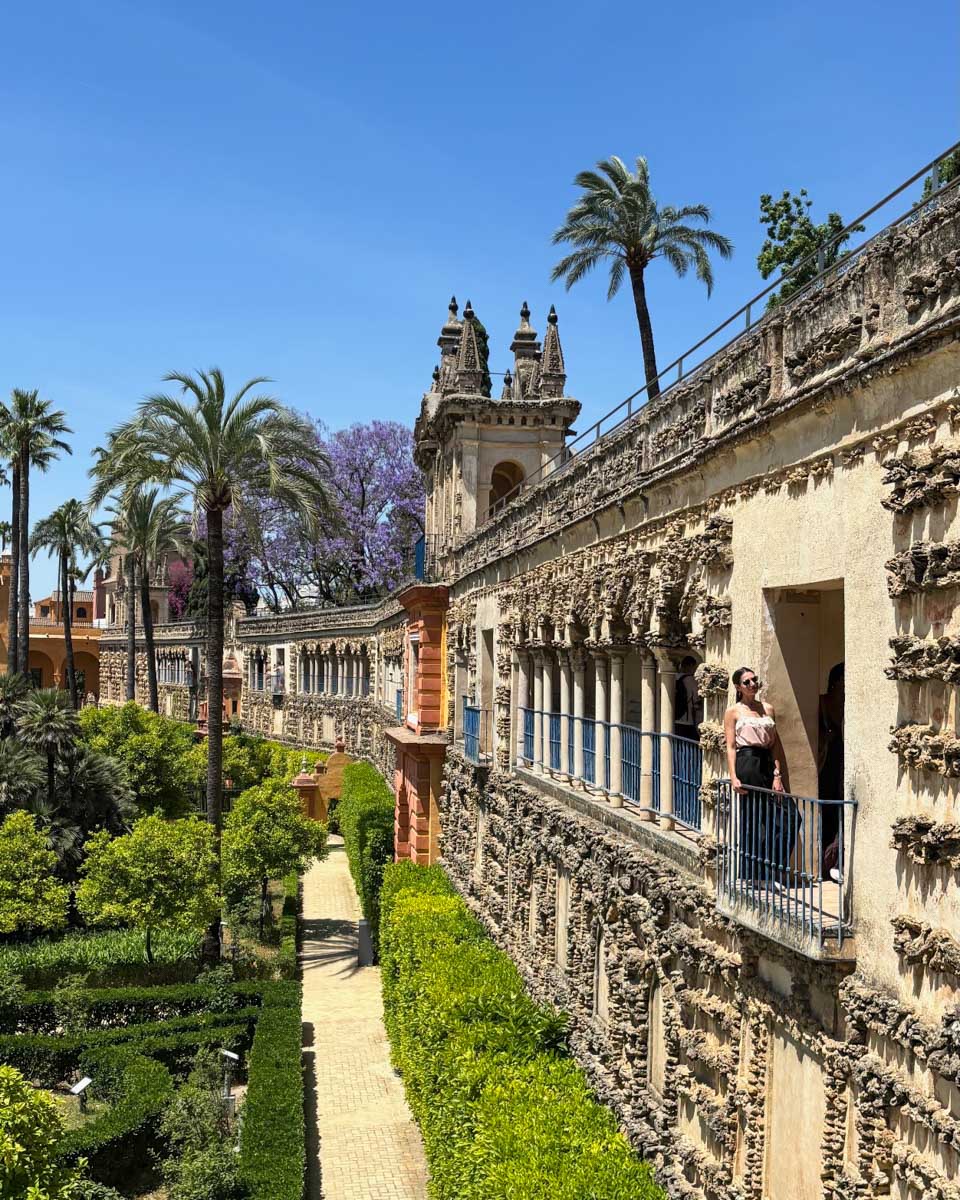 Brittni poses along the wall overlooking the gardens at the Royal Alcazar in Seville