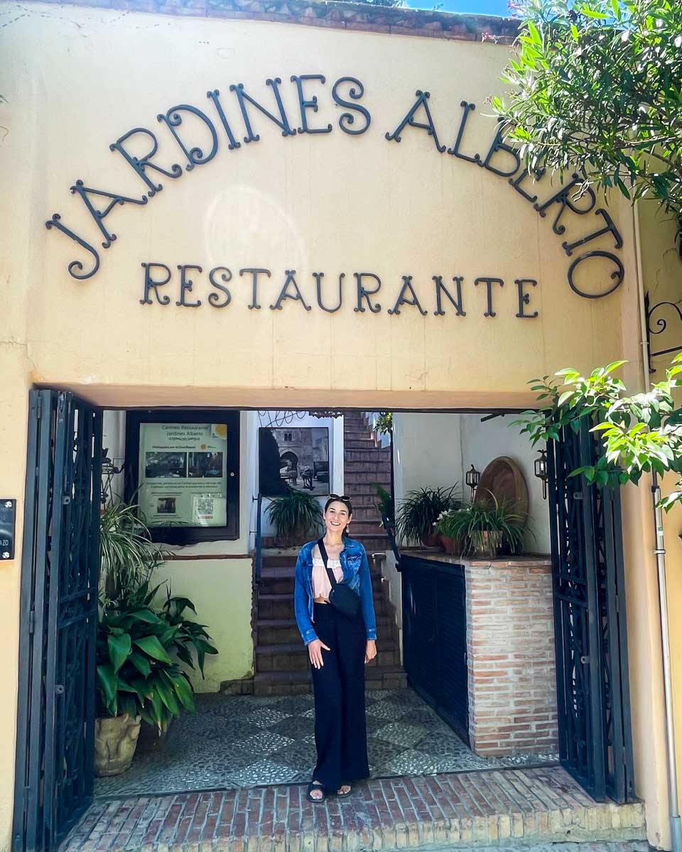 Brittni poses in front of Restaurant Jardines Alberto in Granada