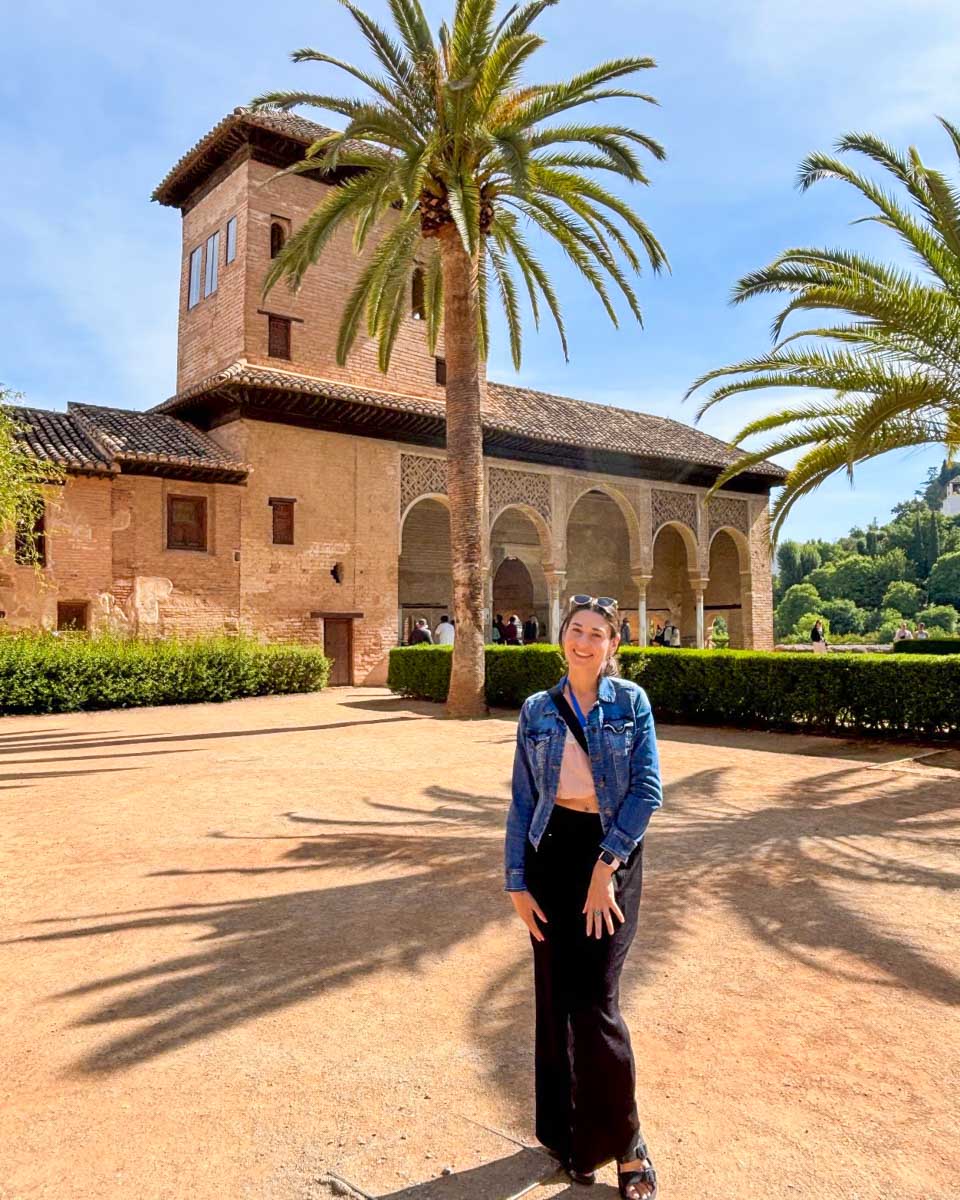 Brittni poses in front of a part of the Alhambra in Granada